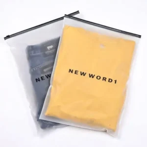 Translucent frosted plastic zipper bag holding folded yellow t-shirt and jeans with custom brand print.
