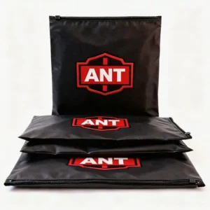 Stacked black custom PVC zipper bags featuring red ANT logo print and durable zip slider closure.