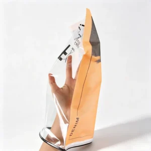 Side view of hand testing the soft touch flexibility and strong side seams of a frosted EVA zipper bag.