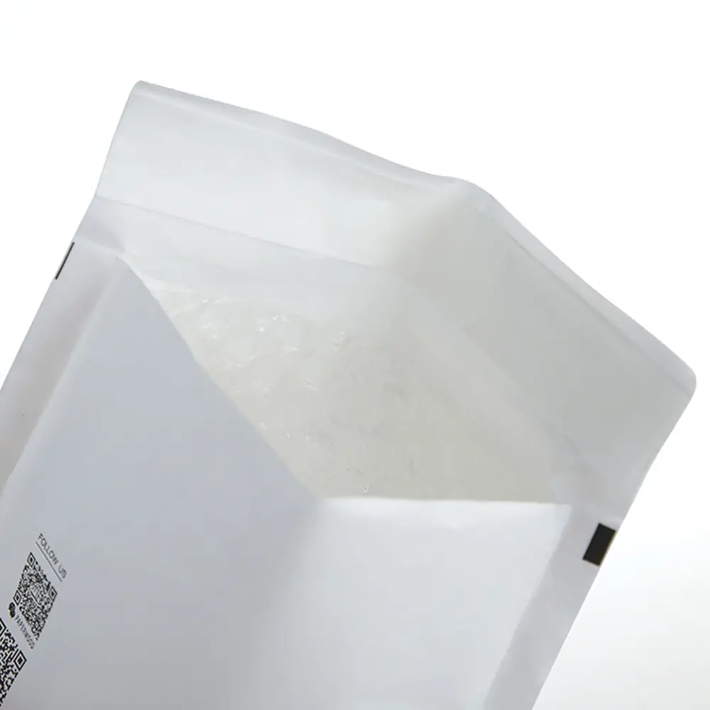 Macro close-up of shockproof polyethylene bubble cushioning lining inside white kraft envelope