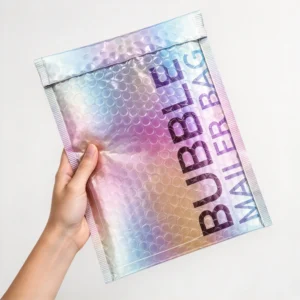 Custom rainbow holographic bubble mailers held in hand for luxury cosmetics and jewelry shipping by PackagingANT