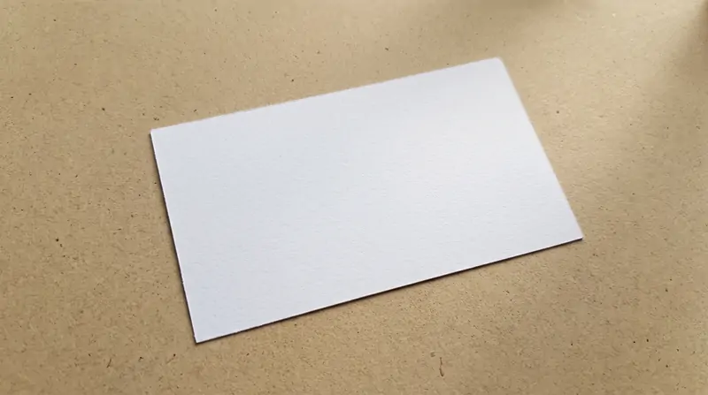 Macro detail of 350gsm rigid white artboard insert cardstock with crisp edge caliper